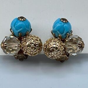 Vintage Vogue ornate clip on earrings. Ab and blue glass .